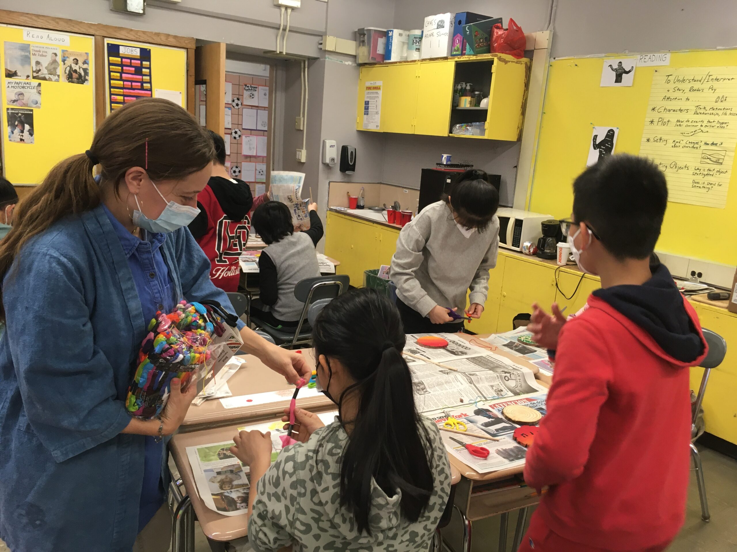 Libby Mislan assists students in creating a mobile, integrating visual arts with poetry.